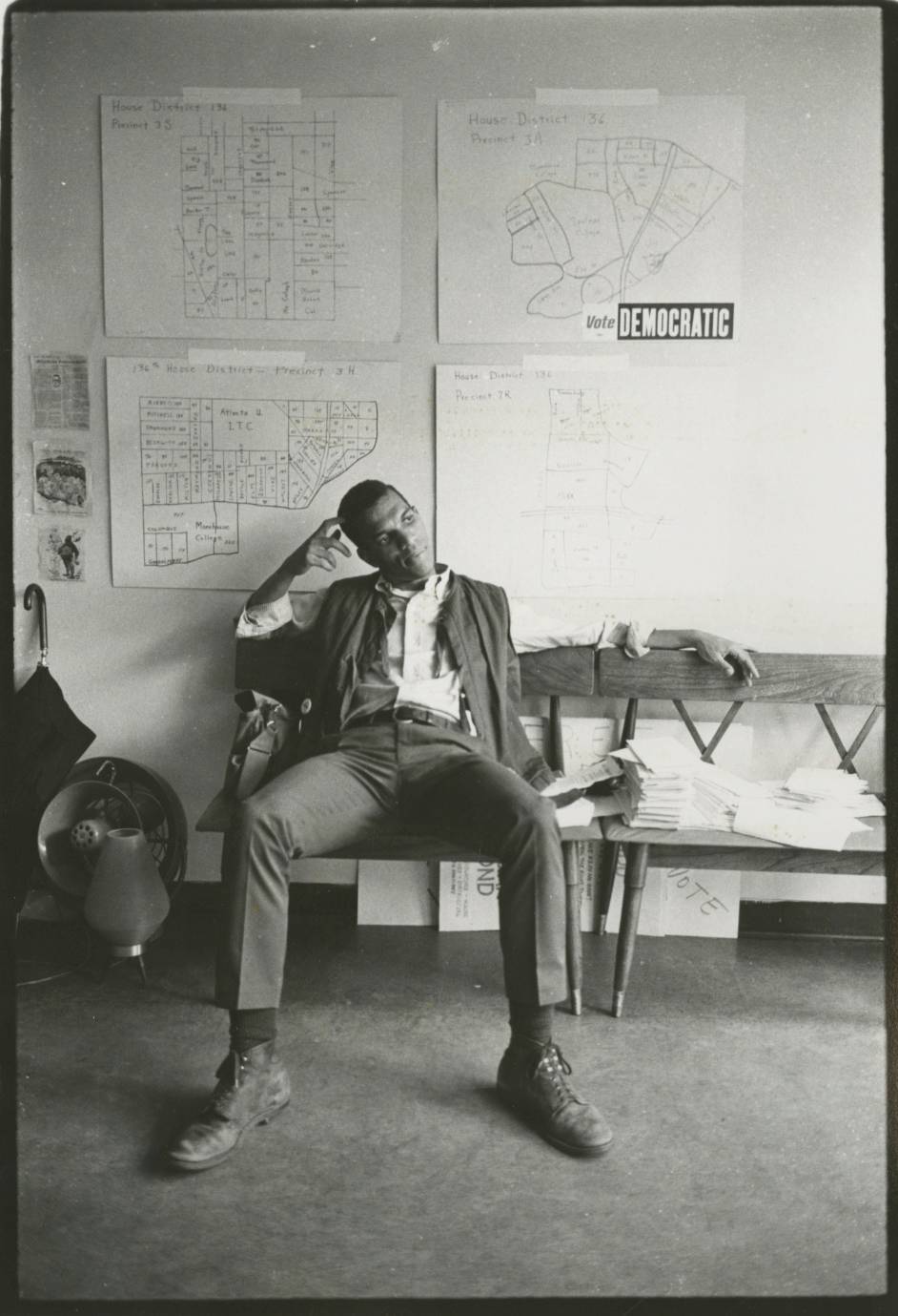 Gilbert black and white photograph of a man, Ivanhoe Donaldson, slouched on a bench, facing the camera.